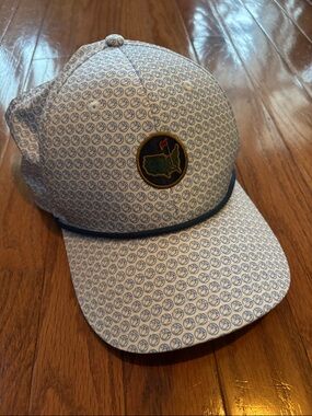 Berkmans Masters White Hat with Blue Repeating Logo Pattern.
